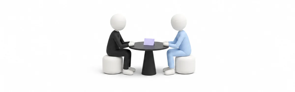 Two figures in conversation at a small table